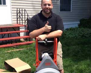 Jack is ready to clear a drain using the power auger